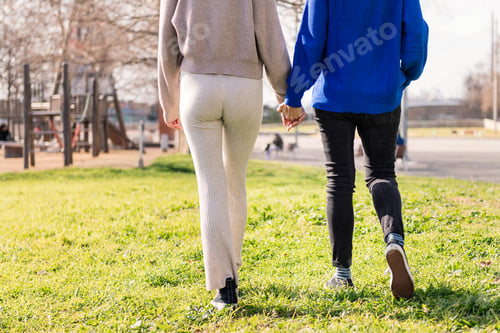 Preview: two women walking together holding hands
