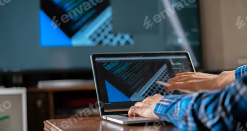 Preview: the male photographer sitting at the table working on computer, using software application