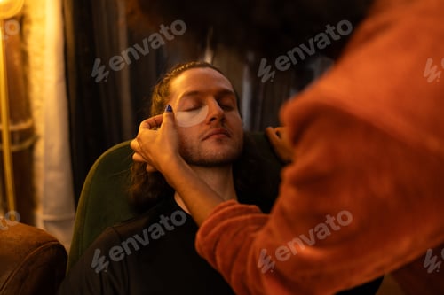 Preview: Beautician carefully placing rejuvenating eye patches