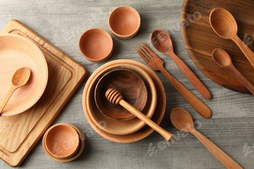Preview: Different wooden dishes on gray table, top view