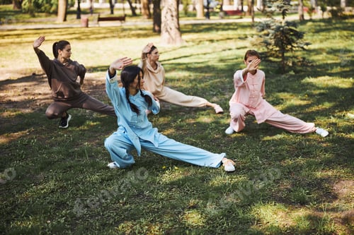 Preview: Women showing snake creeps down pose during outdoor class