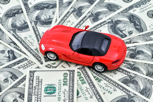 Preview: Concept - toy red car and a pot of money dollar bills.