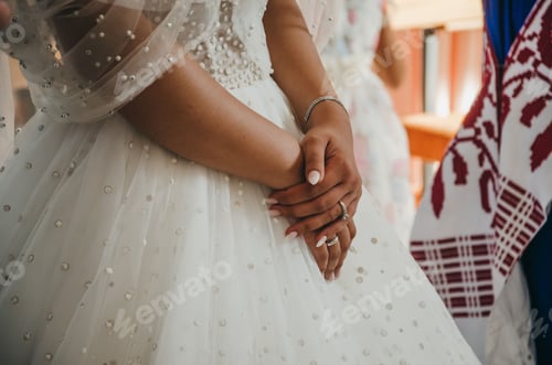 Preview: Closeup shot of the bride holding their own hands during the wedding ceremony