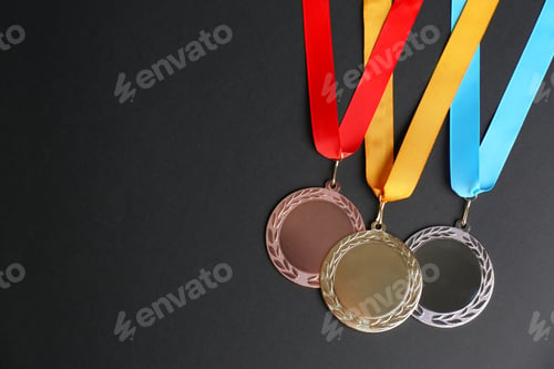 Preview: Gold, silver and bronze medals on black background, flat lay. Space for design