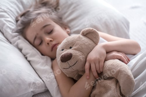 Preview: Little cute girl in bed with toy