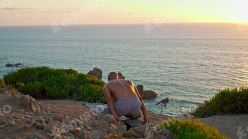 Preview: Man standing head yoga asana at beautiful sunset. Muscular guy training topless