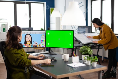 Preview: Woman digital artist working editing creative photo using greenscreen, chroma key isolated display
