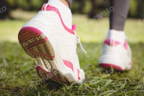 Preview: Fit woman taking a step on a sunny day