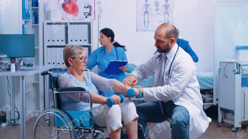 Preview: Doctor helping disabled patient to recover muscle strength