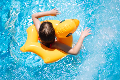 Preview: A little girl with an inflatable circle in the shape of a duck jumps into the poo