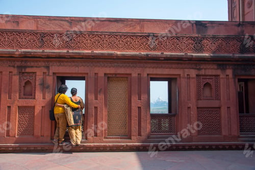 Preview: Romantic Indian couple seeing Taj Mahal from red fort, Agra, India.