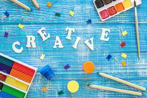 Preview: Colorful school stationery on a wooden background, creative concept, top view.