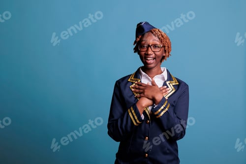 Preview: Female flight worker looking surprised at camera