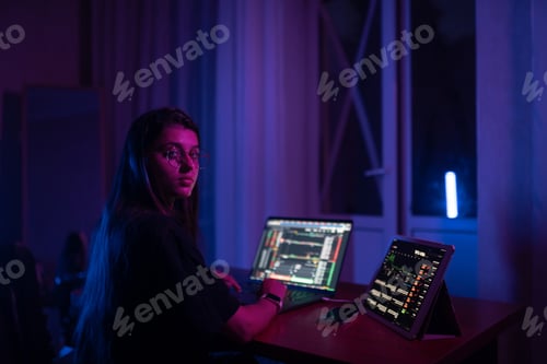 Preview: Attractive young woman working in home at night.