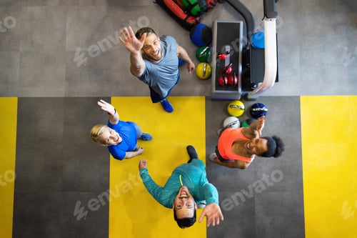 Preview: Young sporty people working out together with kettle bells in a gym