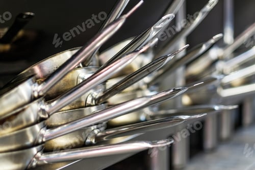Preview: A lot of steel frying pans.
