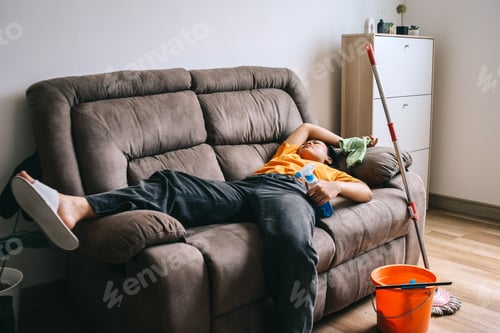 Preview: Exhausted Woman Falling Asleep While Cleanup The Room
