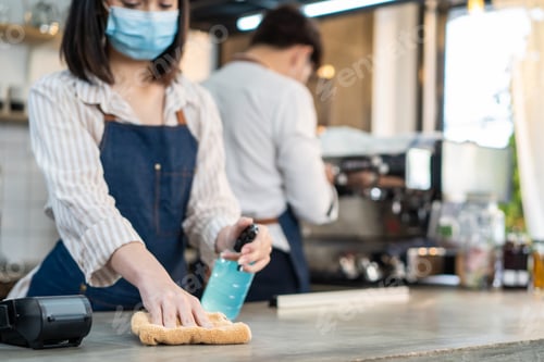 Preview: Cafe waiter wear mask, clean restaurant with sanitizer to open store.