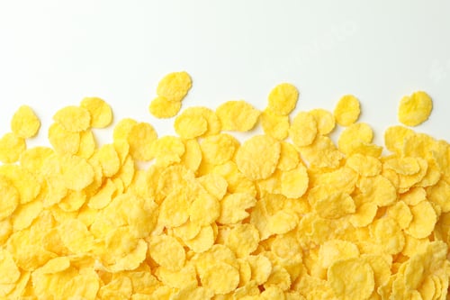 Preview: Dry uncooked corn flakes on white background, close up