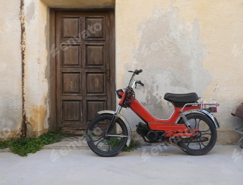 Preview: old motorcycle scooter parked in front of building