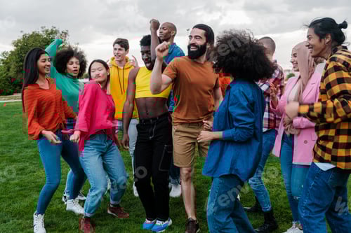 Preview: Group of young people of multi-ethnic origin dancing together outdoors