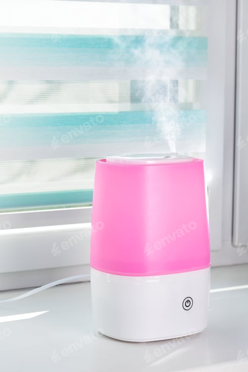 Preview: Pink ultrasonic humidifier on a window moistens dry air