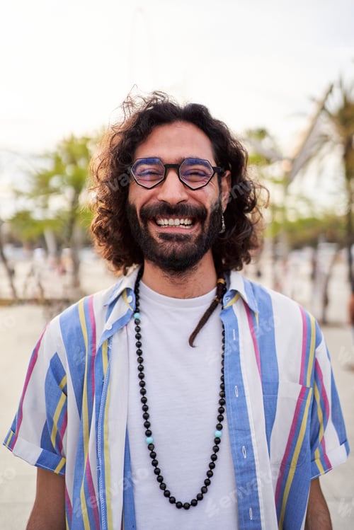 Preview: Smiling Man Wearing Glasses and Striped Shirt Outdoors