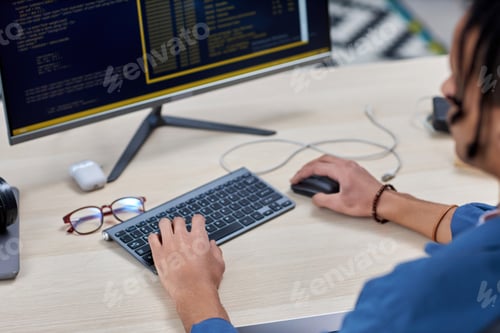 Preview: Closeup of black young man writing code at workplace and using keyboard