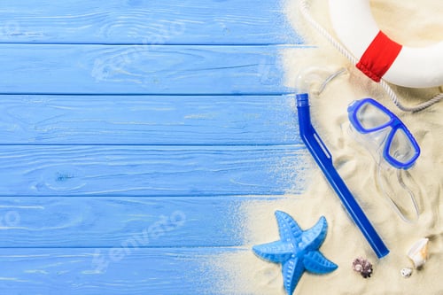 Preview: Beach toys and diving mask on blue wooden background