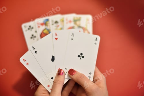 Preview: Woman’s hand holding four aces