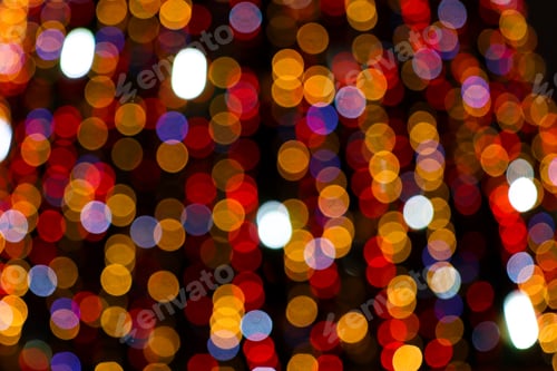 Preview: Festive lights of colorful flowers in the dark, abstract background for the holiday