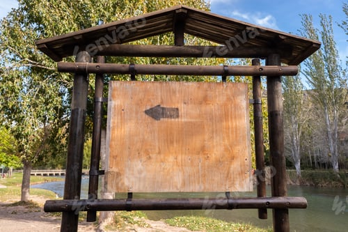 Preview: Blank wooden signpost in a forest, space for copy text.