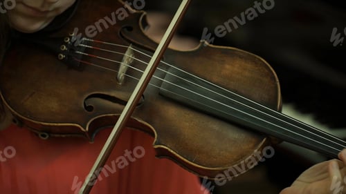 Preview: Girl's hand on the strings of a violin. Girl's hand on the fingerboard violin.