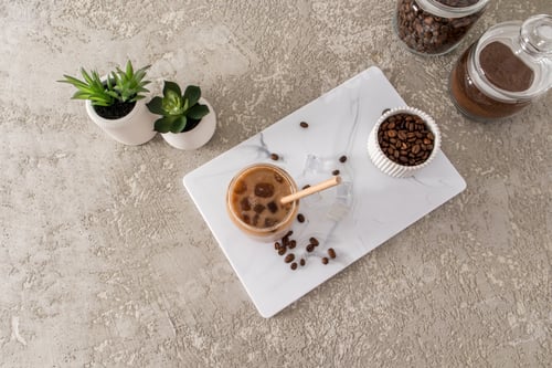 Preview: coffee latte, mocha with milk in a modern glass in the form of a can on a white marble board top vi