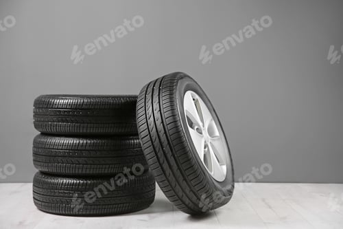 Preview: Car tires near gray wall