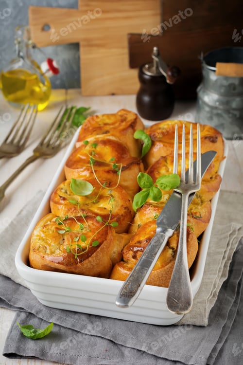Preview: Buns with feta cheese and basil of yeast dough on a light wooden background. Selective focus. Rustic