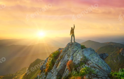 Preview: Silhouette of the winner on mountain peak. Travel image