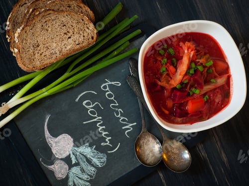 Bowl of Borscht Soup with Bread and Scallions
