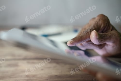 Preview: Hand using digital tablet with touch screen browsing internet and interacting with modern technology