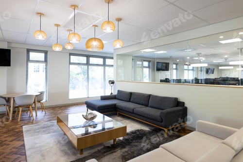Preview: Empty creative office room with glass wall, couch and tv