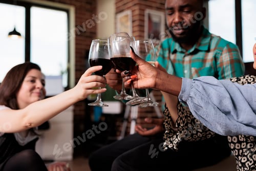 Preview: Happy smiling diverse people clinking glasses while celebrating birthday event
