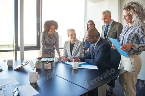 Preview: Diverse group of executives working together around a boardroom table