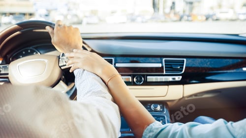 Preview: Close Up of Couples Hands on Steering Wheel While Driving
