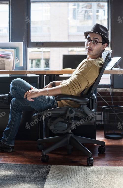 Preview: Hispanic male at his office workstation in a creative office.