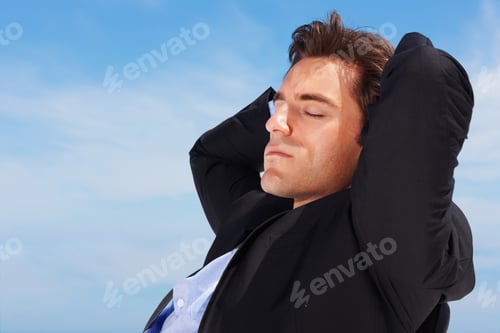 Preview: Closeup of business man sitting relaxed on an chair outdoors
