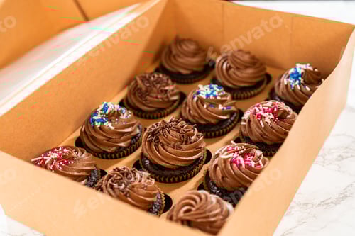 Preview: Chocolate Cupcakes with Sprinkles Inside a Cardboard Box