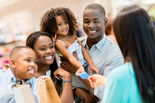 Preview: Happy Shopping Family At The Cashier Paying For Their Purchases