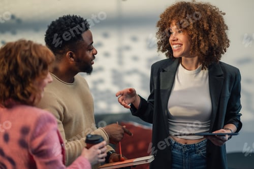 Preview: Interracial business team with tablet discussing business plan at office