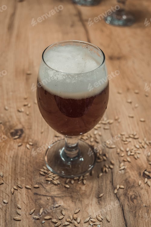 Preview: Vertical shot of a glass of craft beer on a wooden table