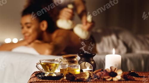 Preview: Woman getting thai herbal compress massage in spa